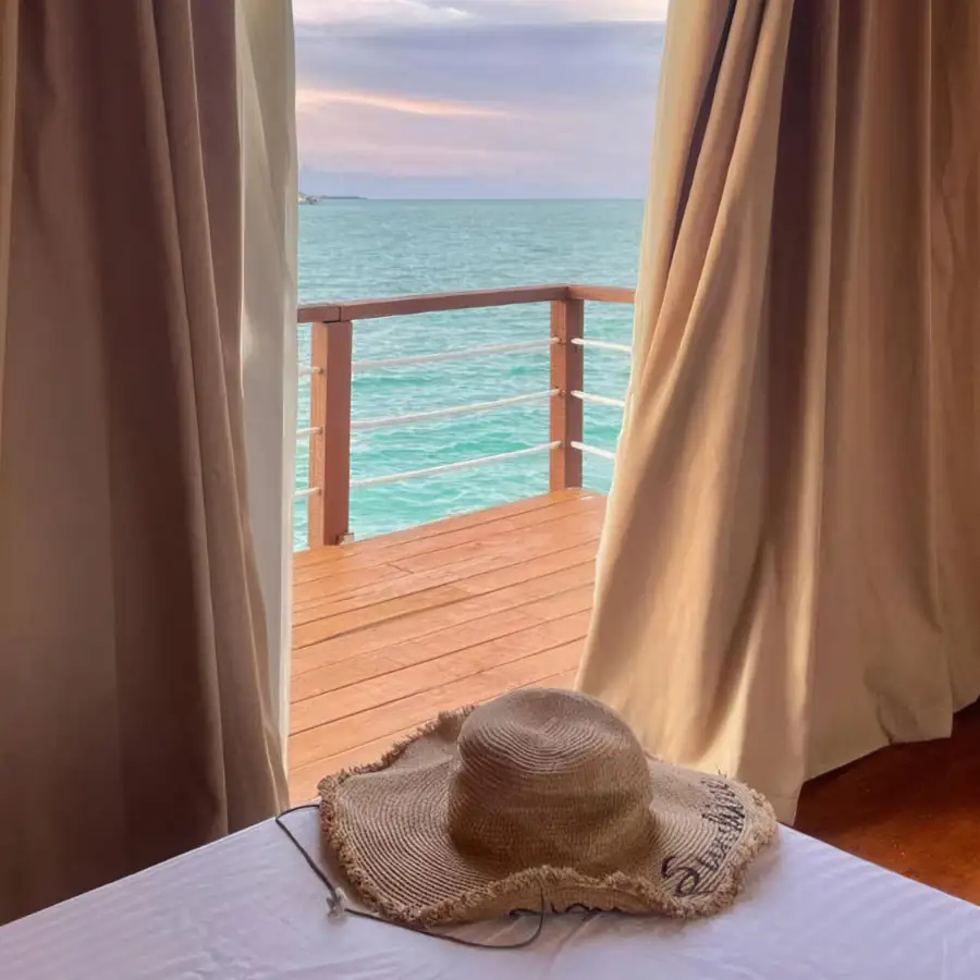 A comfortable family chalet at Coco Seaweed Resort in the Celebes Sea offering two large beds, modern style accents, polished wood floors, and air con.