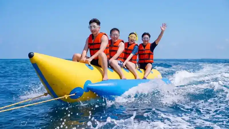 Riding a banana boat with Coco Seaweed Resort near the Tun Sakaran Marine Park in the Semporna archipelago.