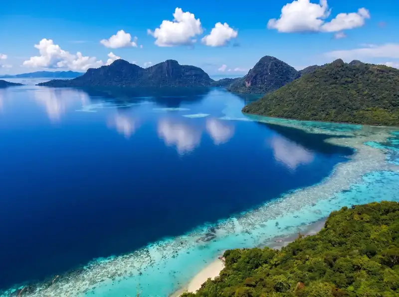 Hiking the Bohey Dulang hill for the lagoon view with Coco Seaweed Resort in the Semporna archipelago.