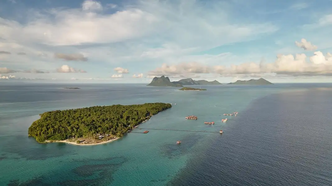 Aerial drone view of island hopping boats and reef lagoons Coco Seaweed Resort